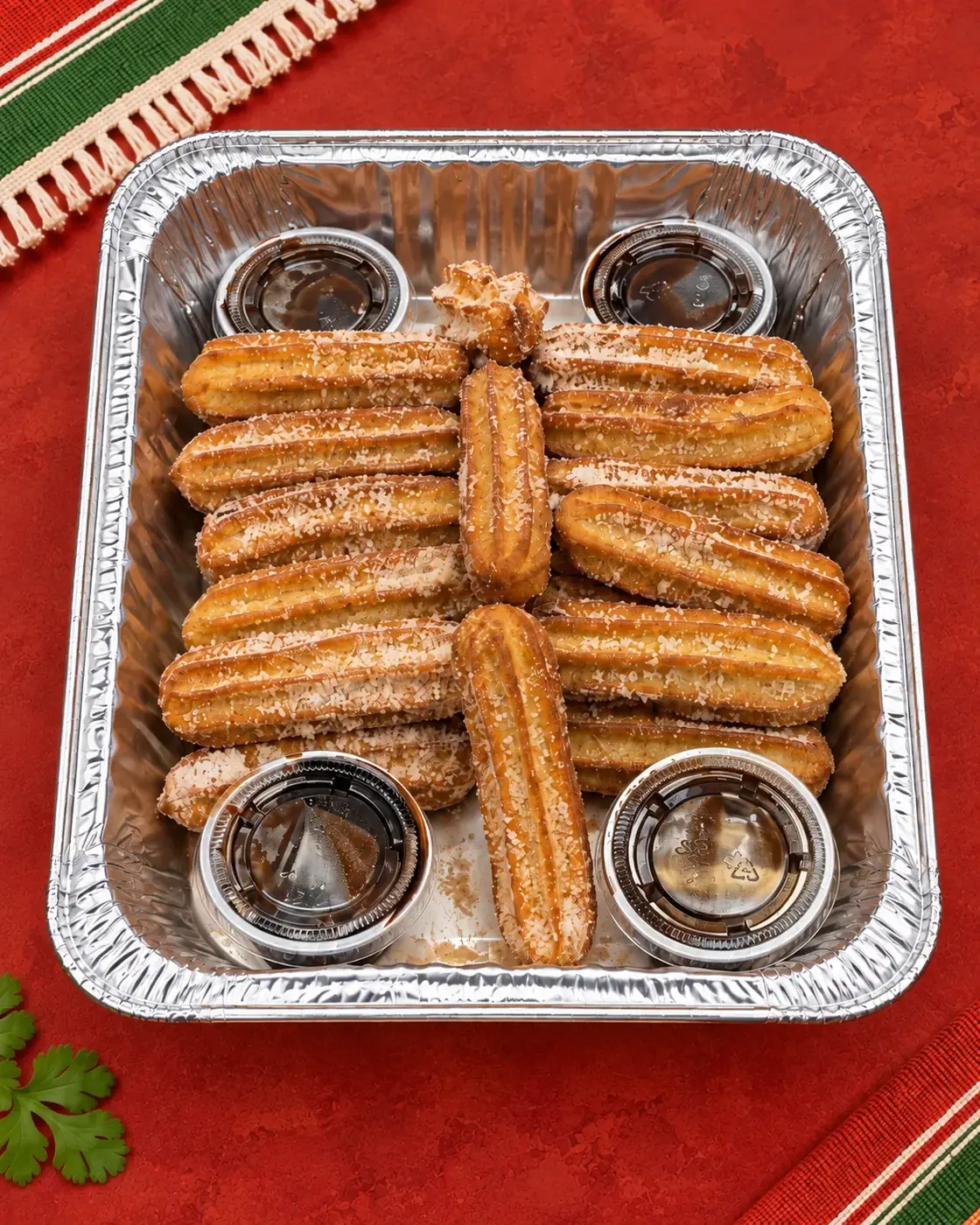 Catering tray filled with churros and dipping sauces