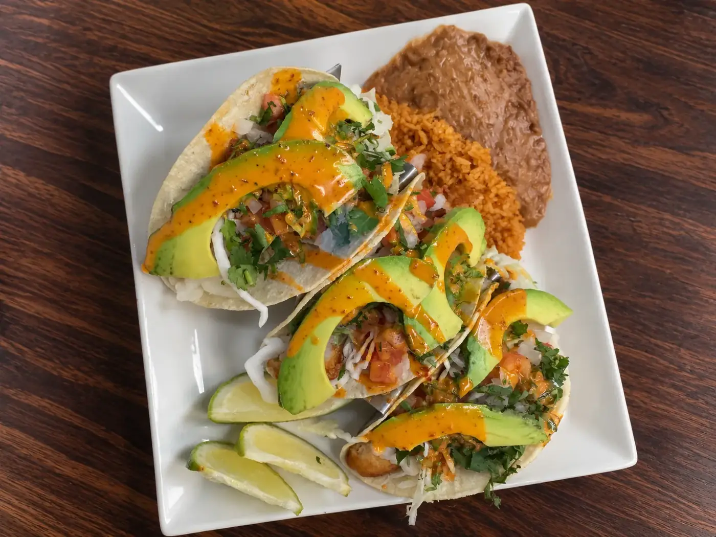 Chicanos tacos topped with avocado, pico de gallo and house sauce